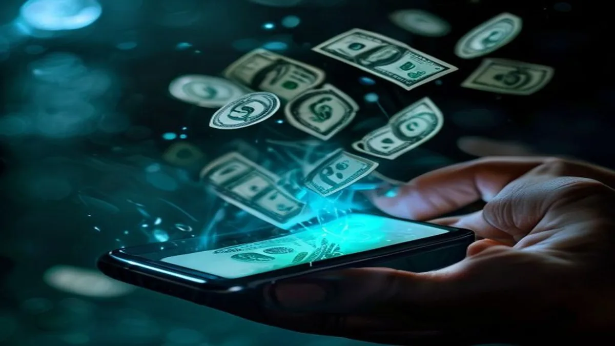 Hand tapping a Cash Out button on a smartphone with US dollar bills materializing above it.